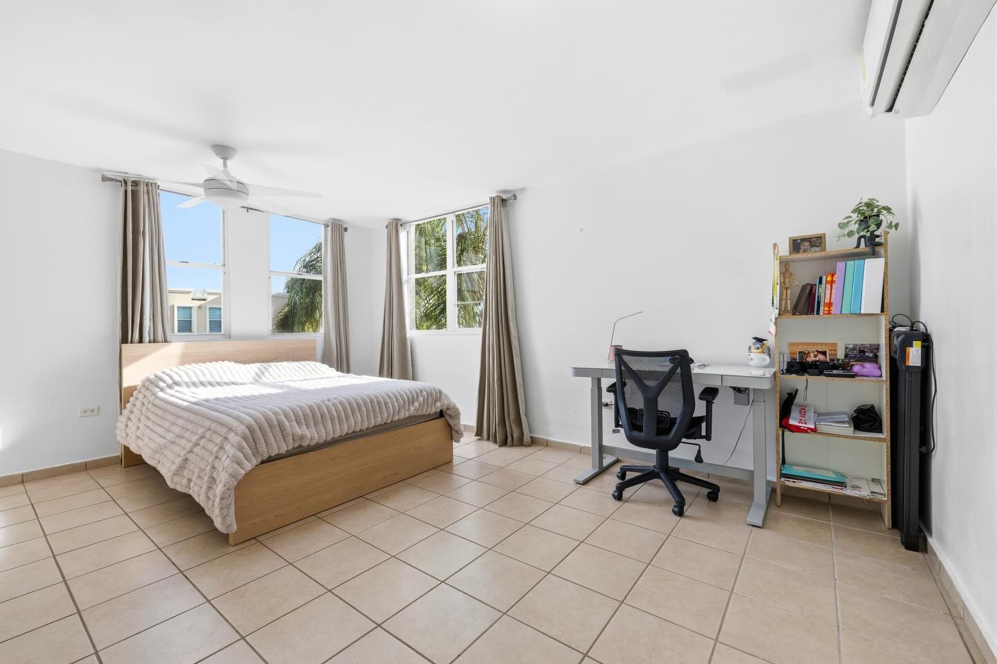Primary bedroom with king bed and workstation